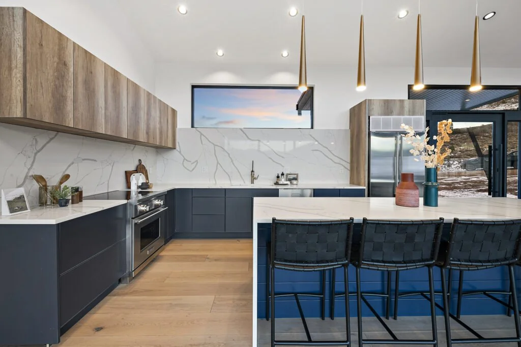 Icon-House-Benloch-Heber-City-Kitchen-Blue-Cabinetry-Wood-Uppers-Quartz-Backsplash-Brass-Pendants-Roderick-Builders-Modern-Custom.jpg