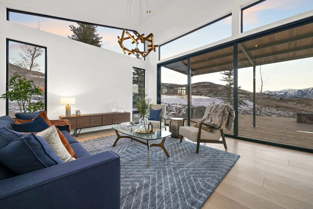 Icon-House-Benloch-Heber-City-Living-Room-Vaulted-Ceiling-Sliding-Doors-Geometric-Rug-Mid-Century-Credenza-Roderick-Builders-Modern-Custom.jpg