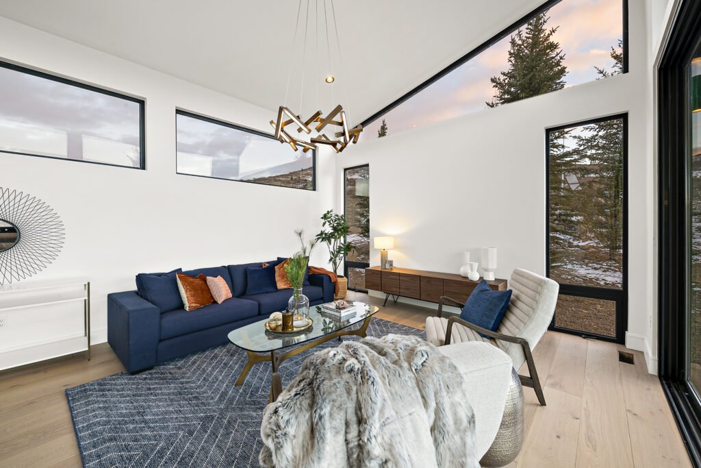 Icon-House-Benloch-Heber-City-Living-Room-Vaulted-Ceiling-Navy-Sofa-Wood-Credenza-Artistic-Lighting-Roderick-Builders-Modern-Custom.jpg