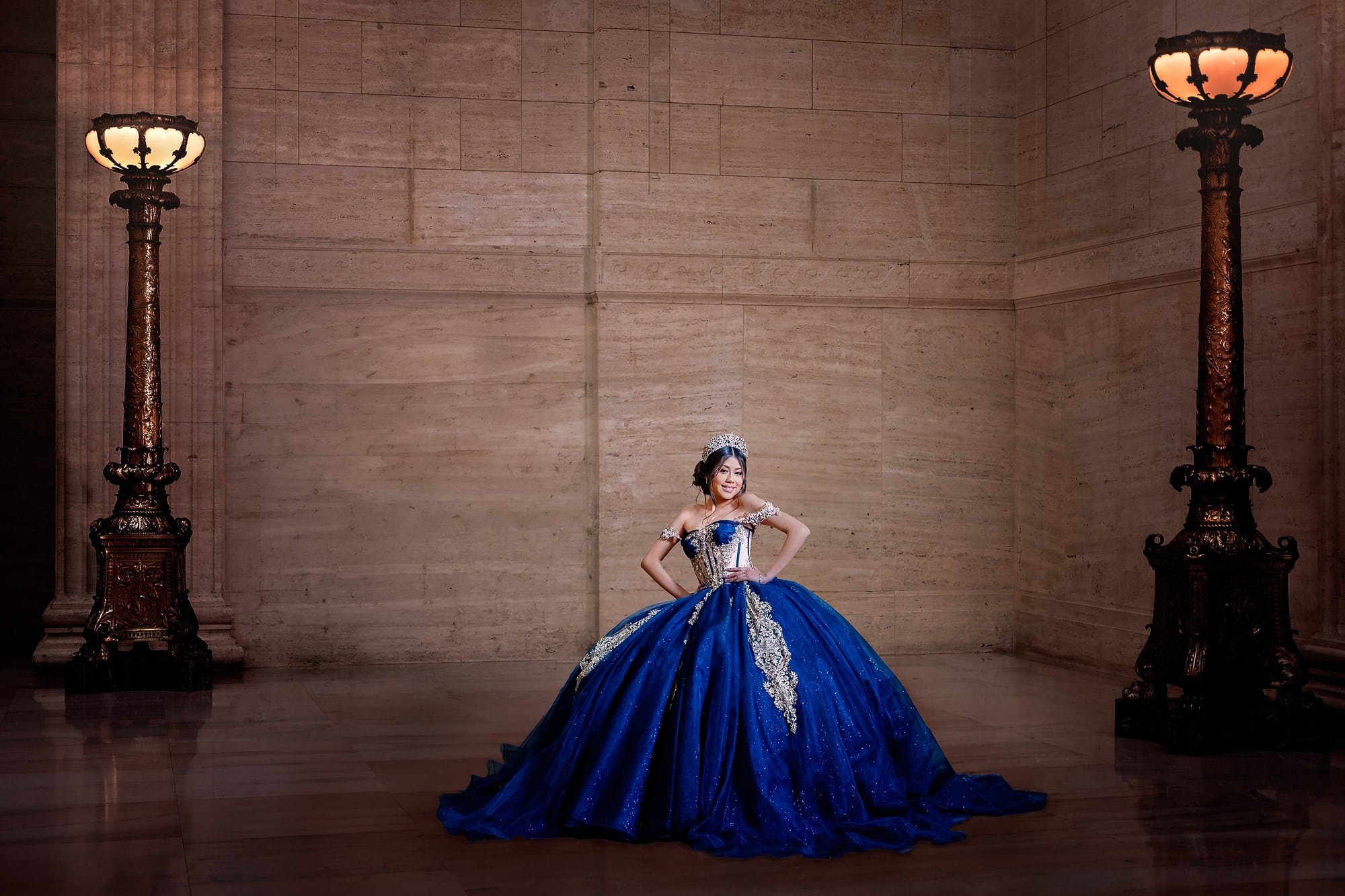 Quinceañera in a royal blue ball gown during a photoshoot at Union Station in Chicago.