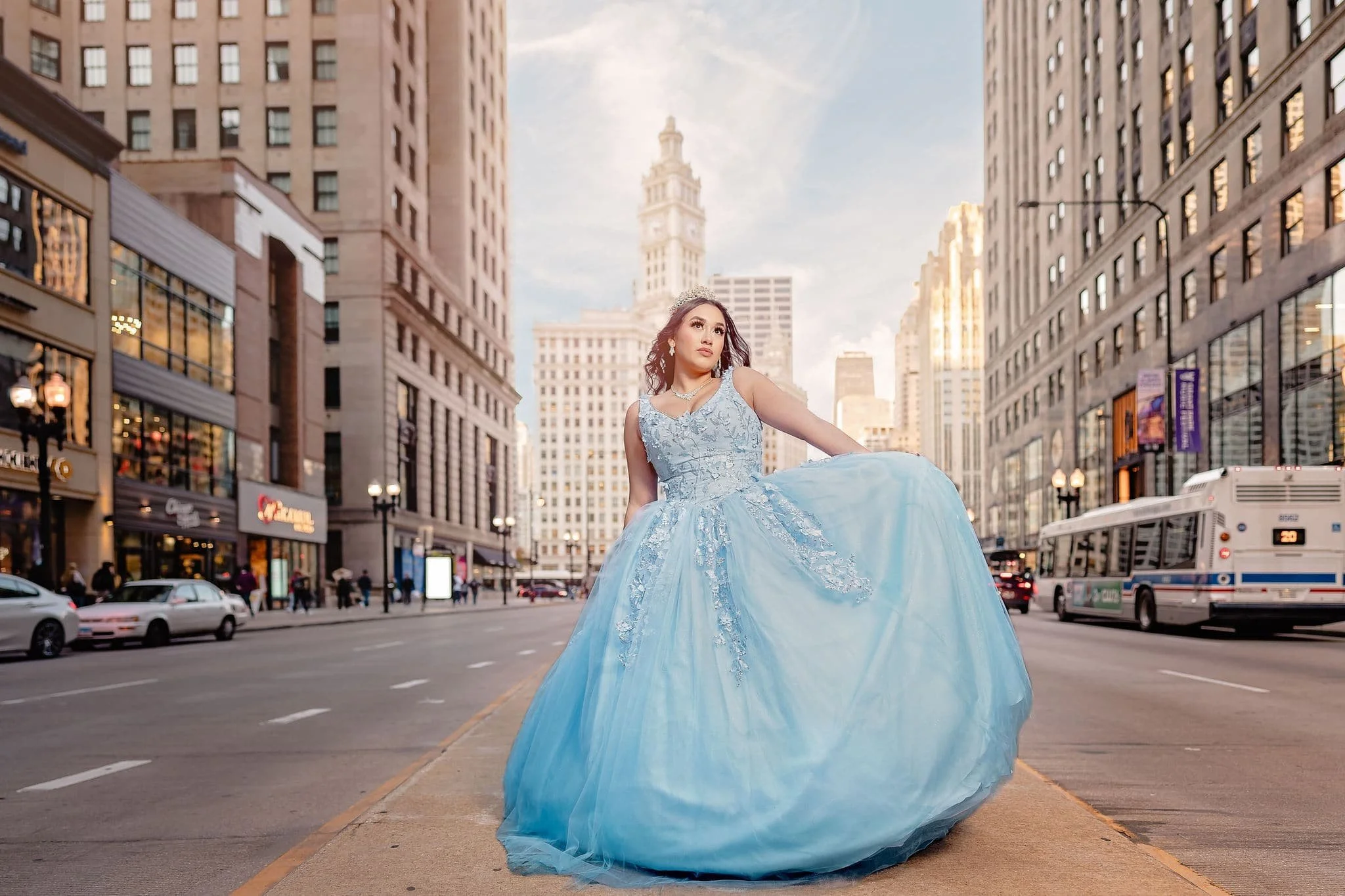 Quinceañera dancing in her blue ball gown in downtown Chicago with the city skyline in the background