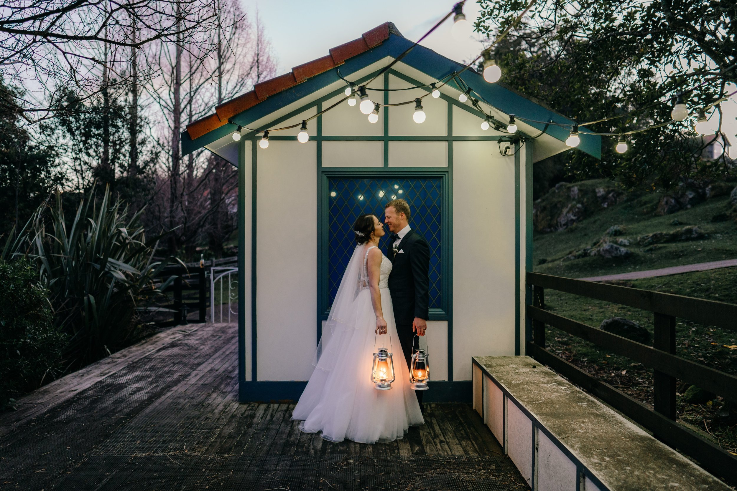  Bride and Groom with lanterns wedding photo at On the Point Lake Rotorua 