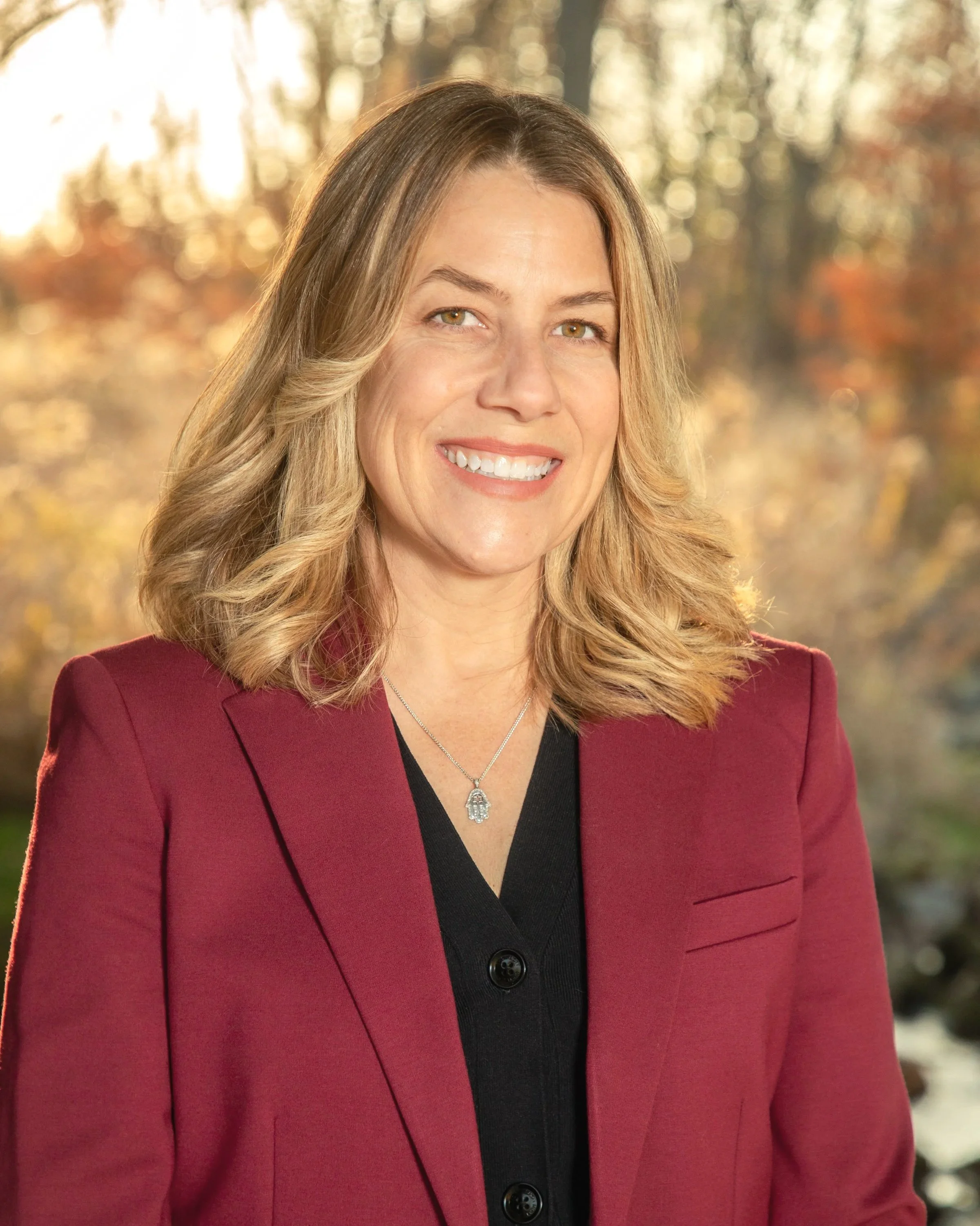 Woman standing in front of a autumn landscape