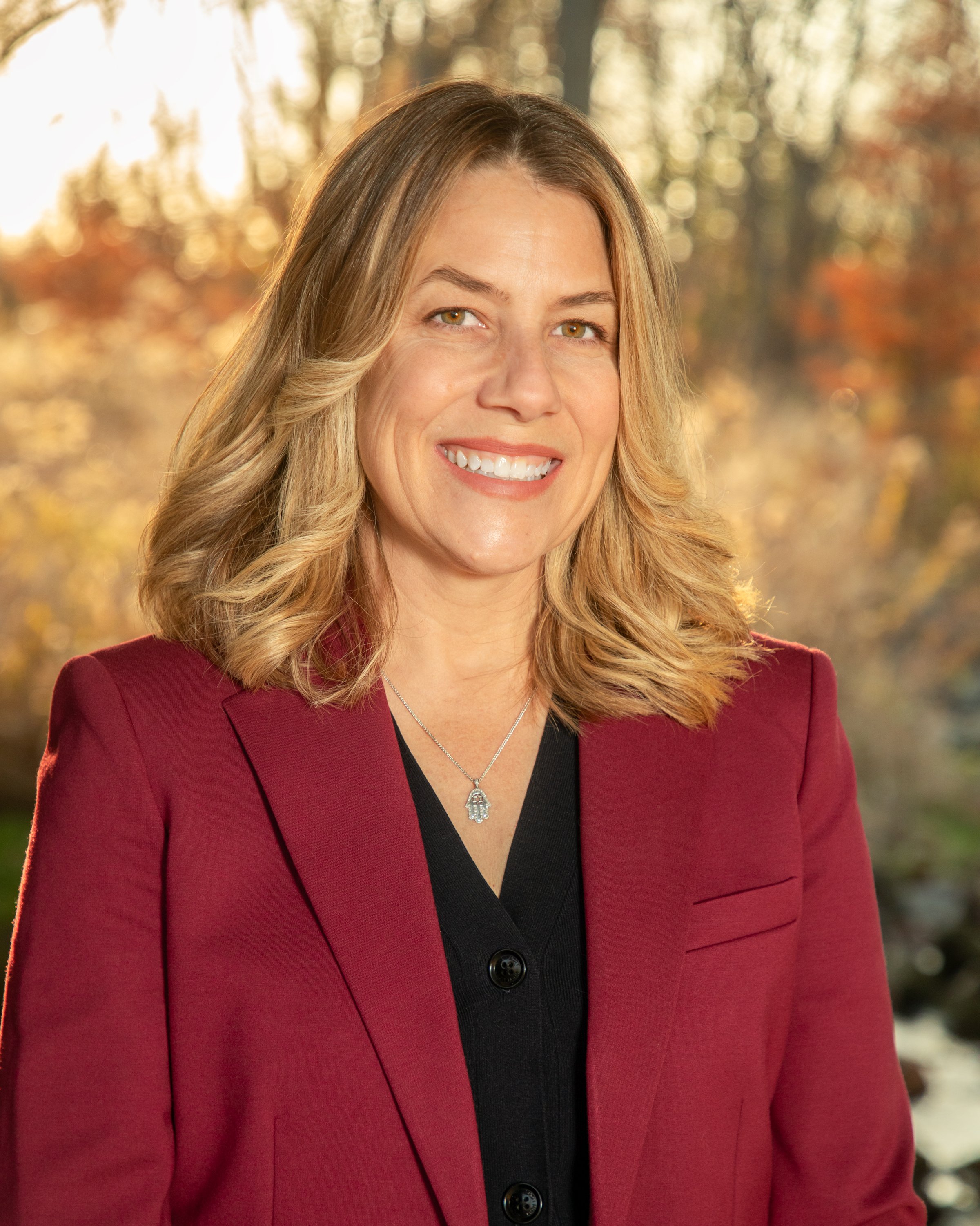 Woman standing in front of a autumn landscape