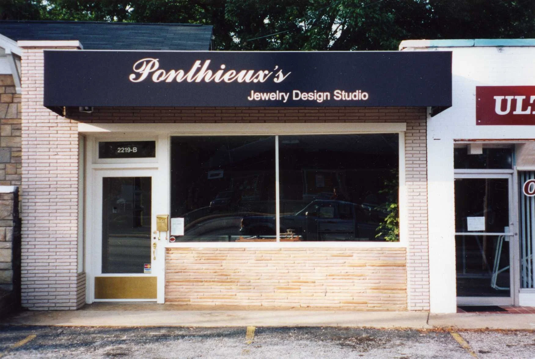 Storefront of Ponthieux's Jewelry Design Studio with a brick facade, large glass window, and signage displaying the store name. The entrance has a door labeled 2219-B adjacent to the window.