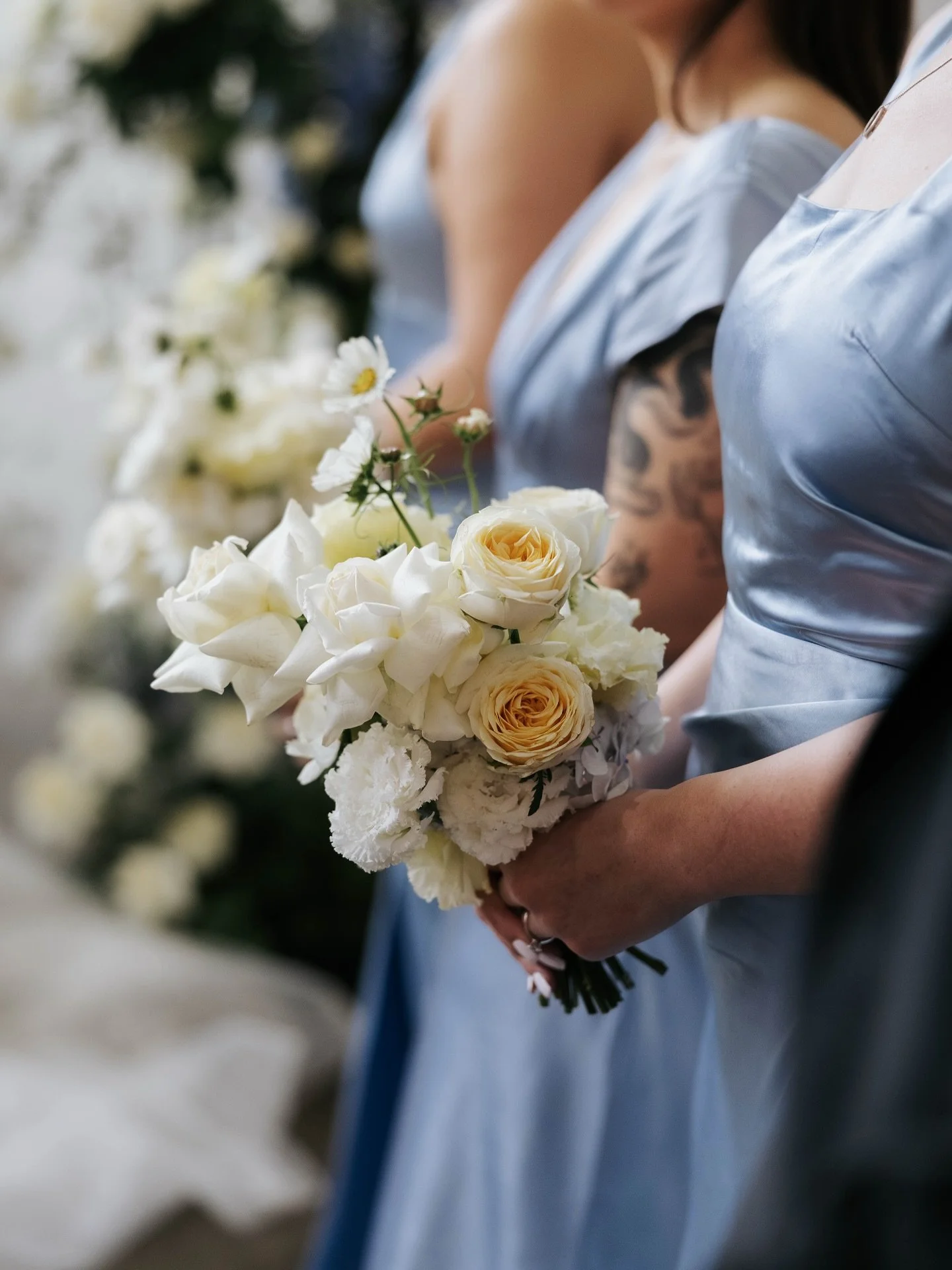 PSA for wedding party members everywhere: bouquets belong at belly button height (not boobs!). Keep them low, keep them pretty, and keep those photos flawless.

This tip works well for walking down the aisle or standing up the front during the ceremo