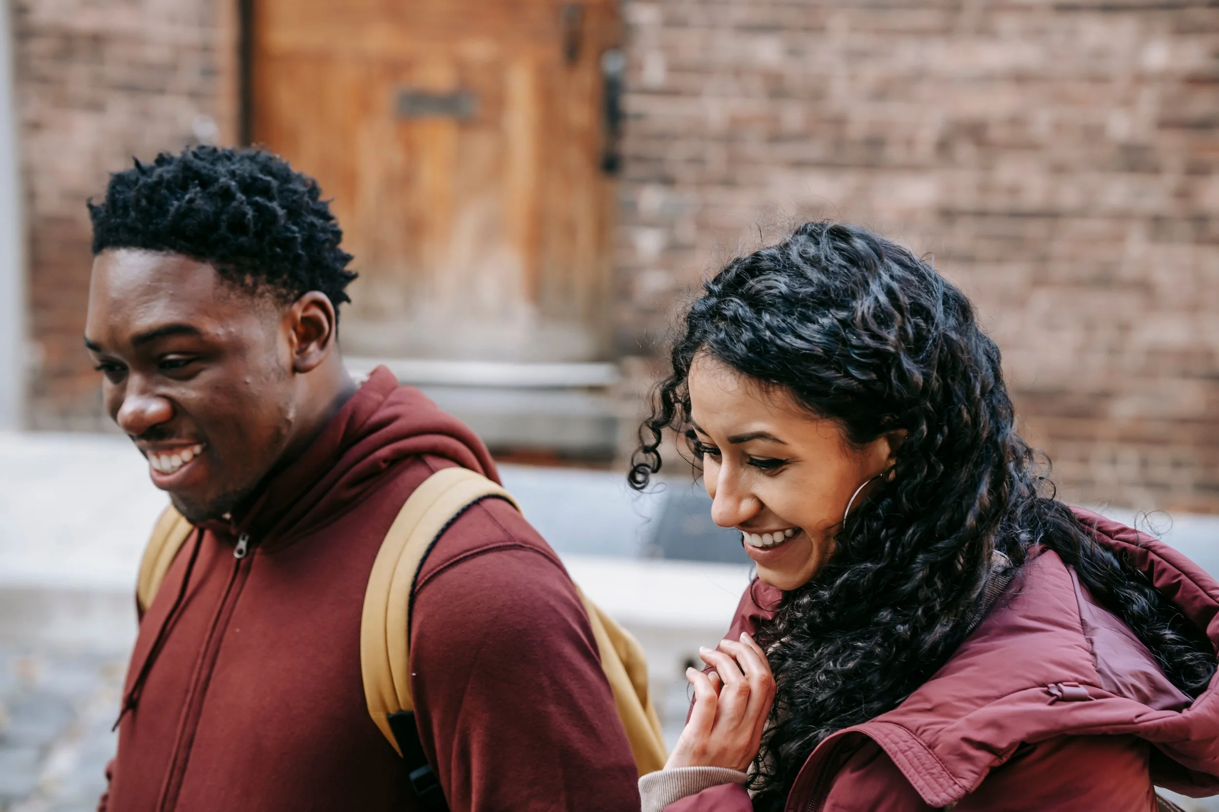 A man and woman walking together and smiling