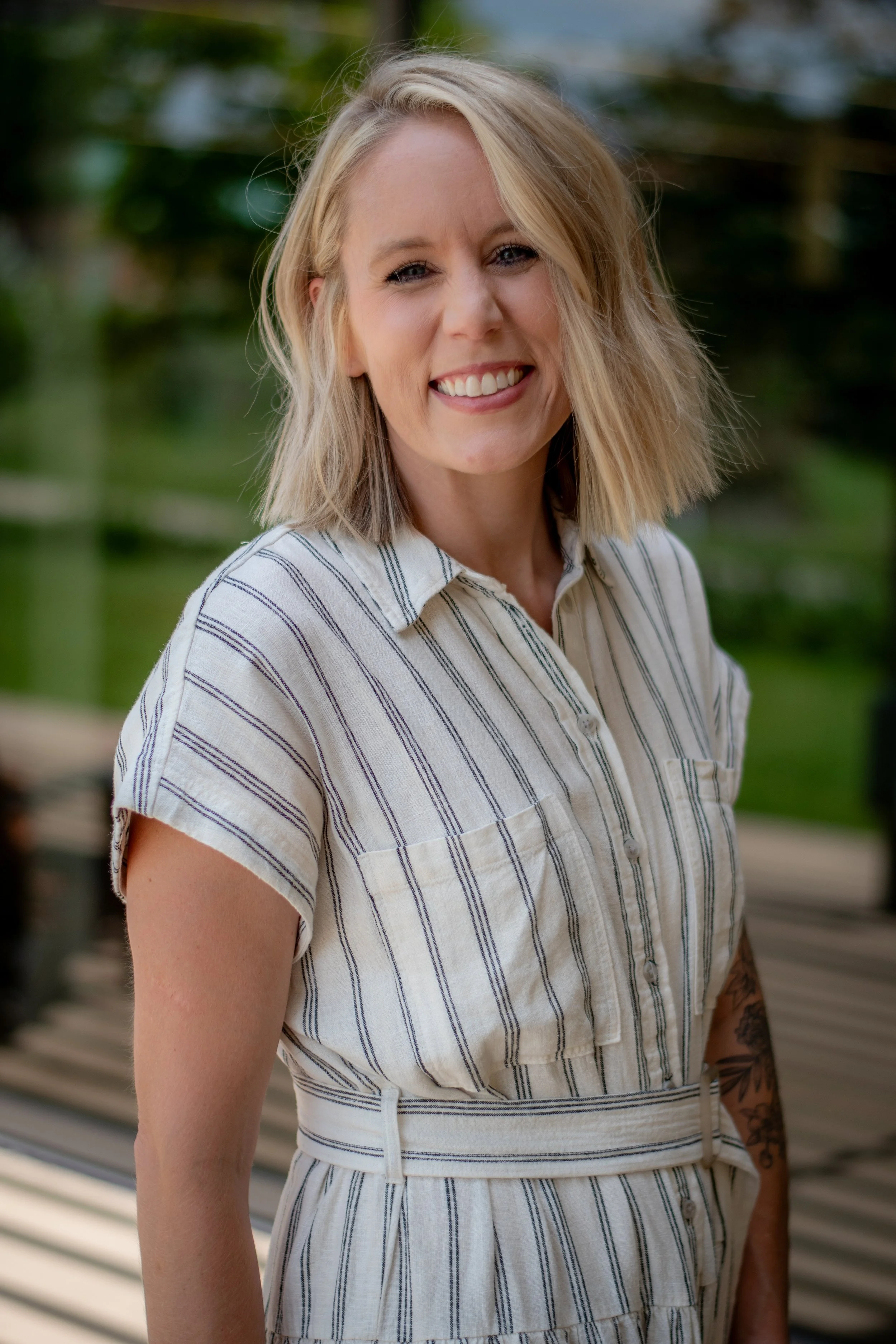 Therapist Courtney Sailer standing and smiling outdoors