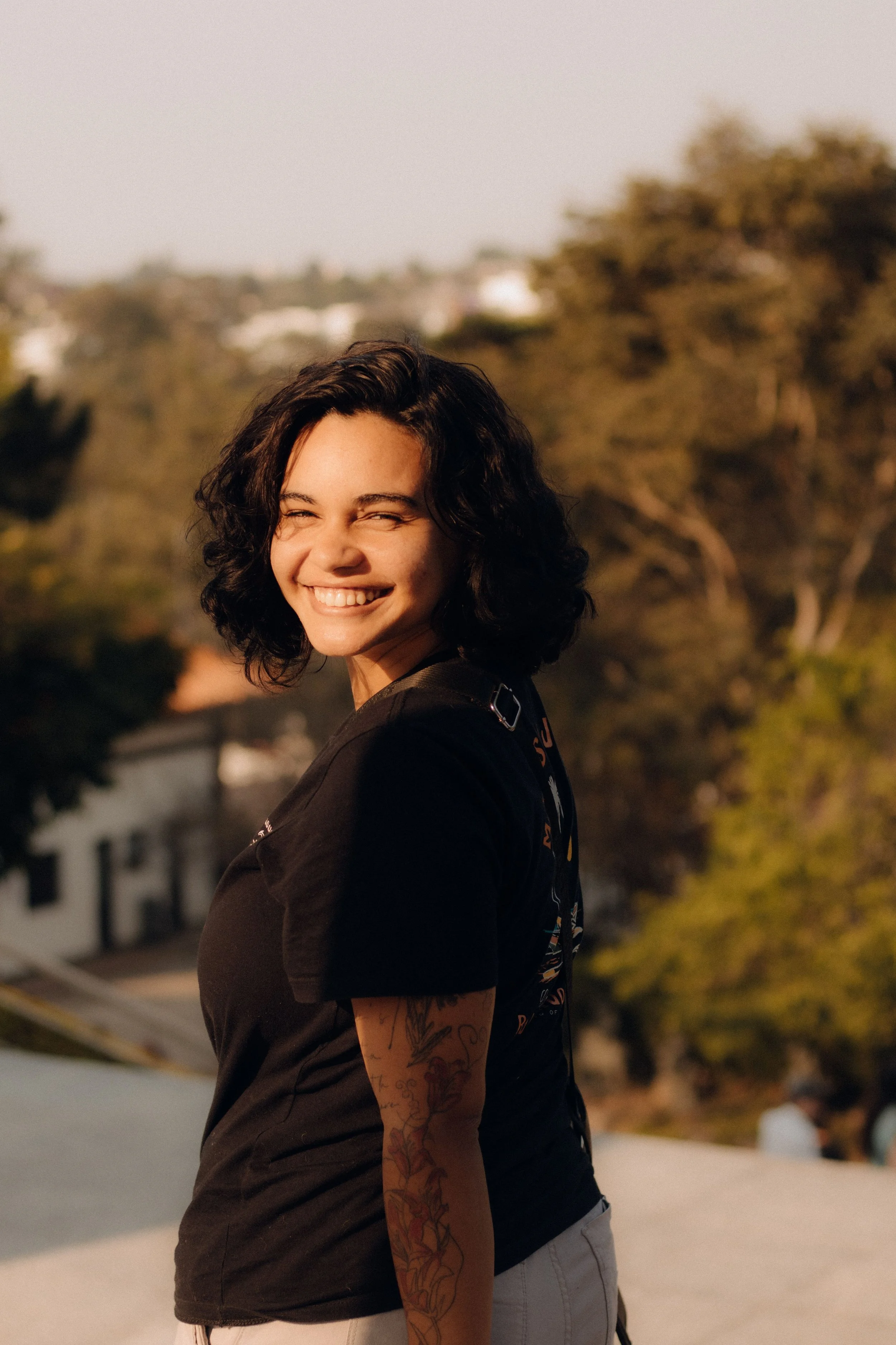 Women with dark hair turned back and smiling