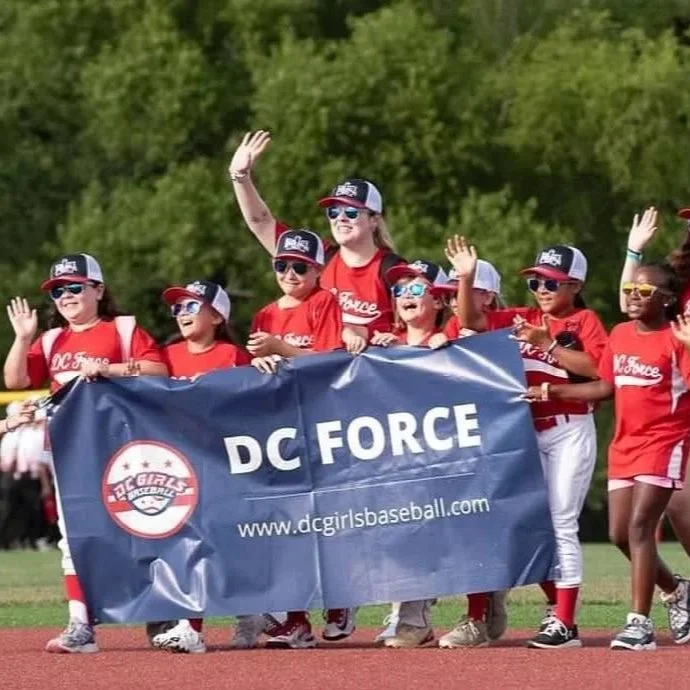 DC Force players and coaches waving and holding the DC Force banner.