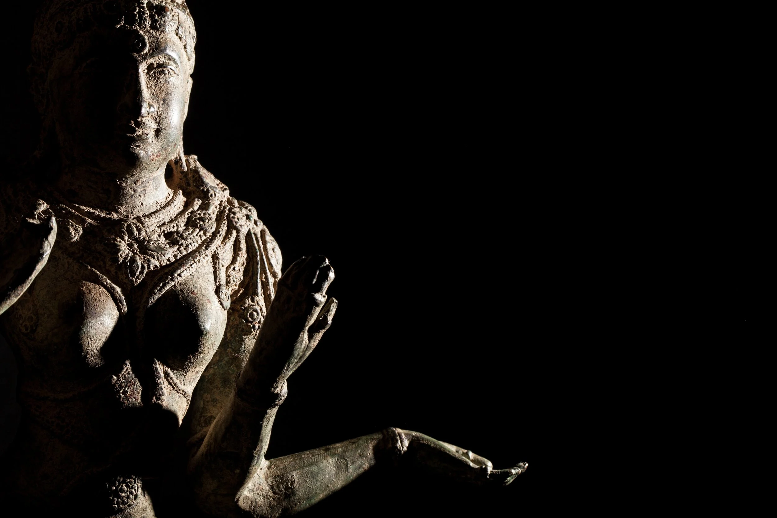 Ancient meditative statue of Lakshmi representing inner stillness, nervous system regulation, gratitude, and the journey from scarcity toward sufficiency and sustainable wealth.