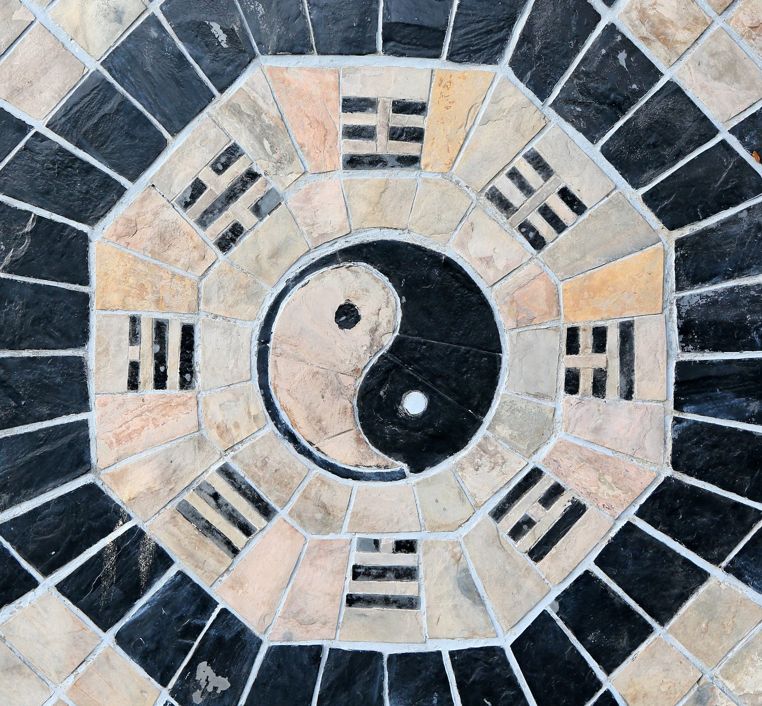 Ancient yin and yang mosaic symbolizing divine masculine and feminine balance, polarity, and aligned energy for conscious wealth and business growth.