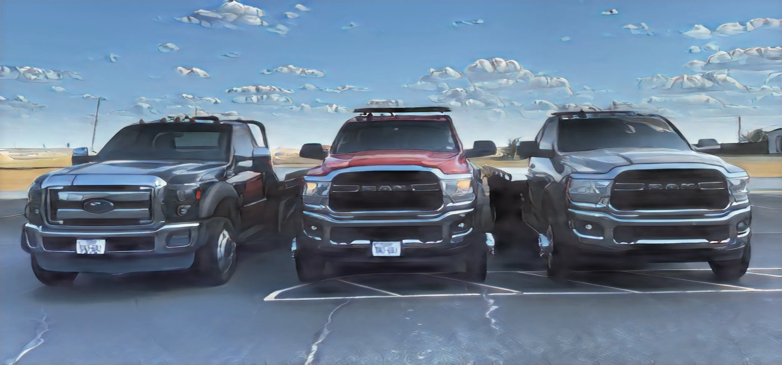 Three pickup trucks parked side by side in a parking lot on a partly cloudy day.