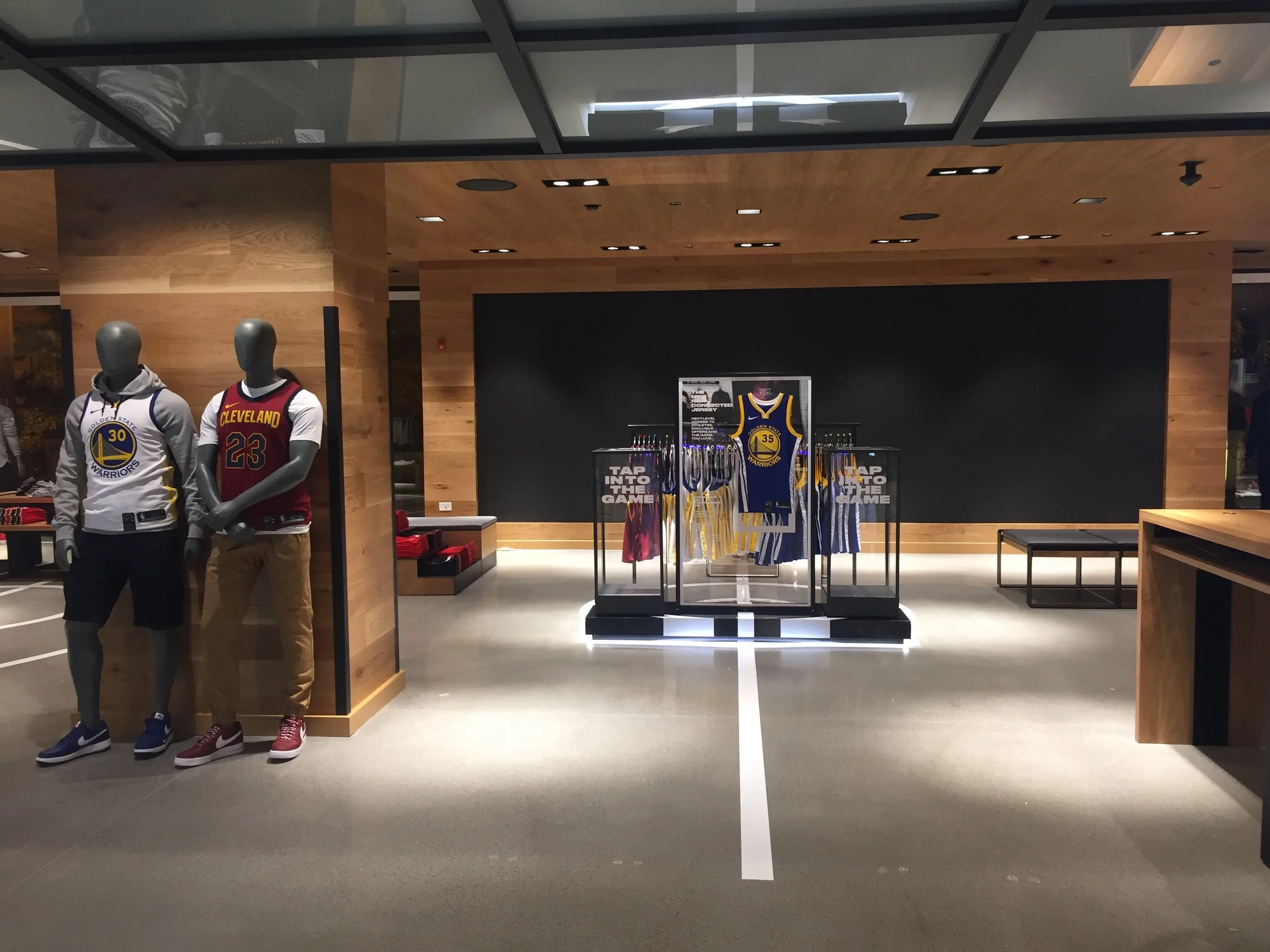 Entrance view of Nike NBA connected jersey display at Champs State Street Chicago