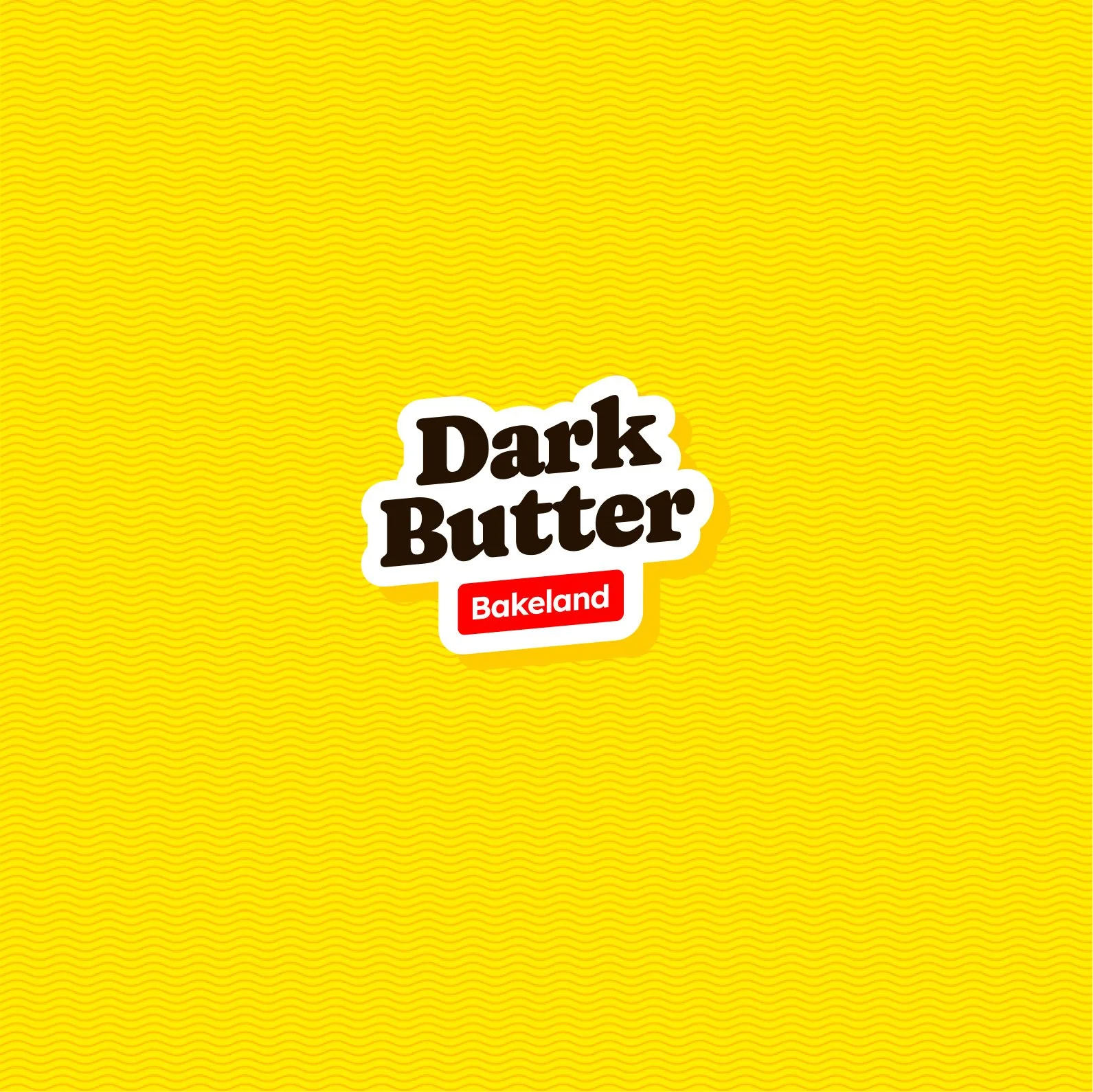 DarkButter Bakeland brand identity — bold retro logo with buttery yellow background symbolizing indulgent, nostalgic flavor.