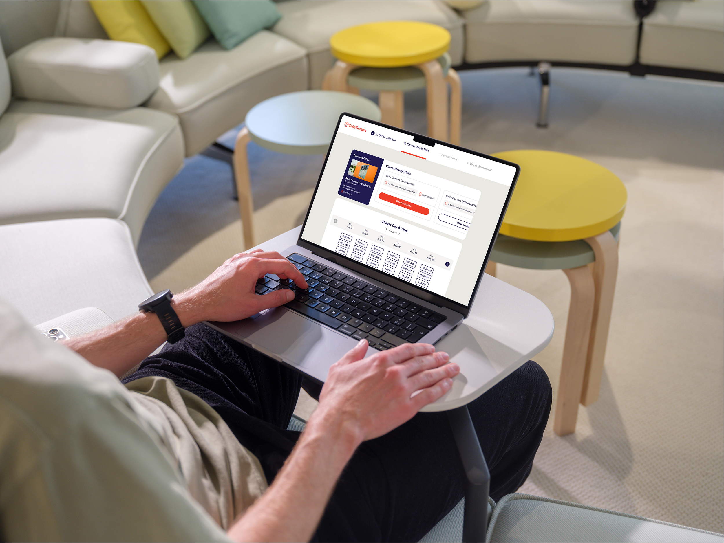 MacBook Pro mockup with a man in a casual workspace (Mockuuups Studio).png