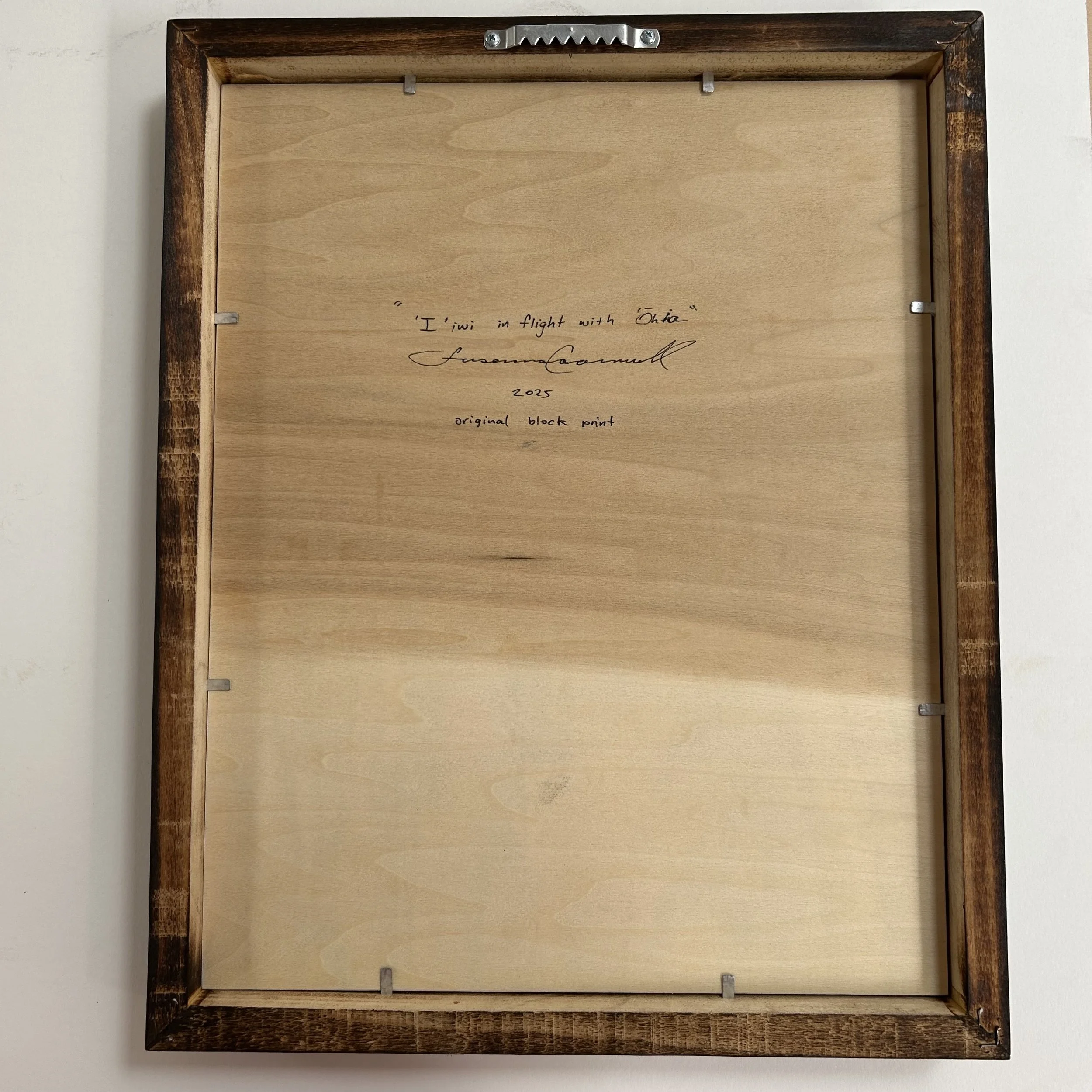 Iiwi in flight with Ohia Back.jpg