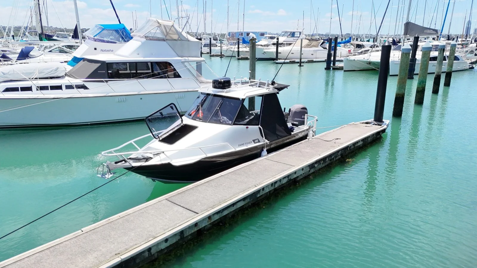 The Focus Game Fisher boat moored at a marina pontoon