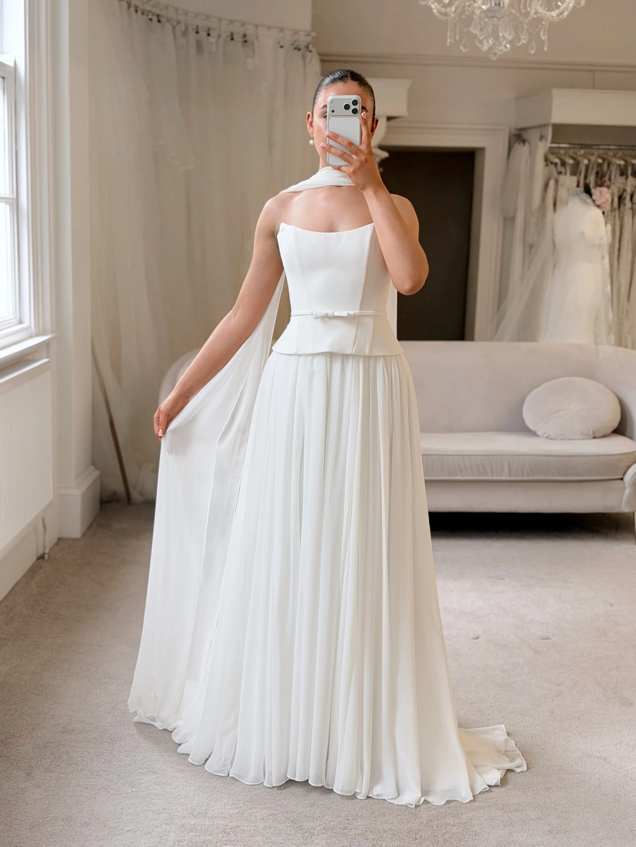 Modern romance in @mikaellabridal. Sculpted structure meets soft, fluid movement, finished with a delicate waist detail and elegant neck scarf. Understated, refined and effortlessly timeless. 

Book your appointment today via the link in our bio 🤍👰