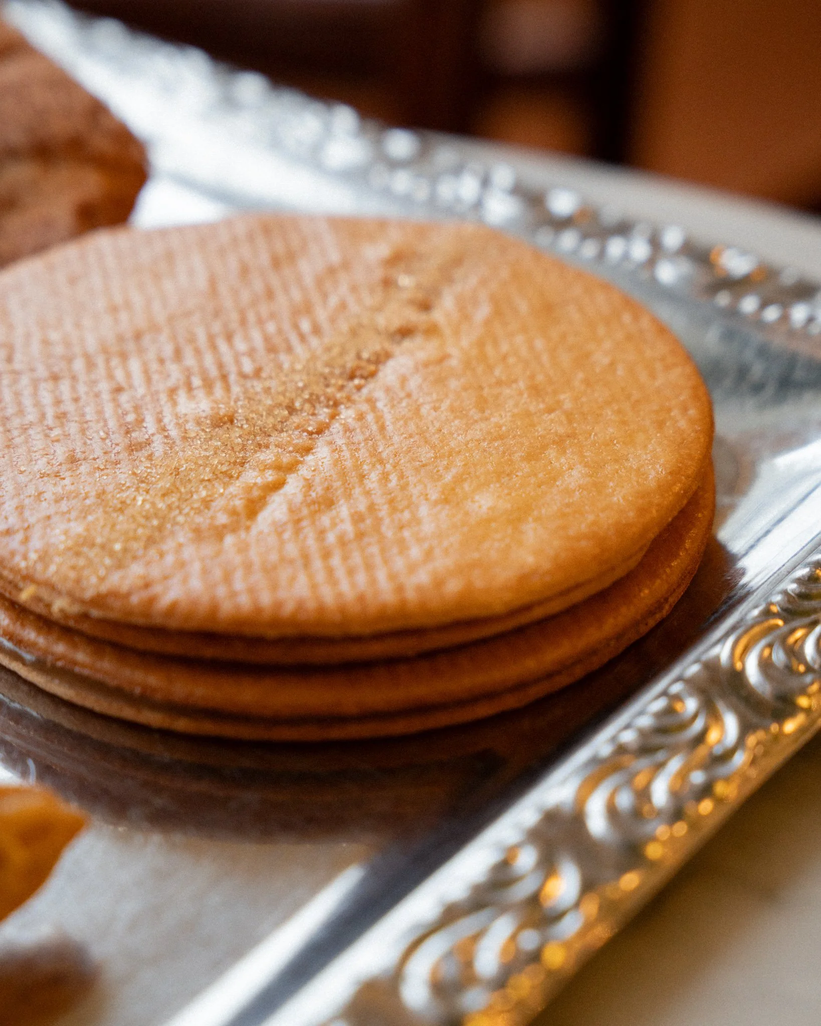 Close-up of a stack of cookies on a silver tray.