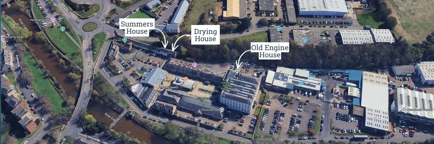 Aerial view of a complex with labeled buildings: Summers House, Drying House, Old Engine House, nearby parking lots, roads, a river, green areas, and various commercial and industrial structures.