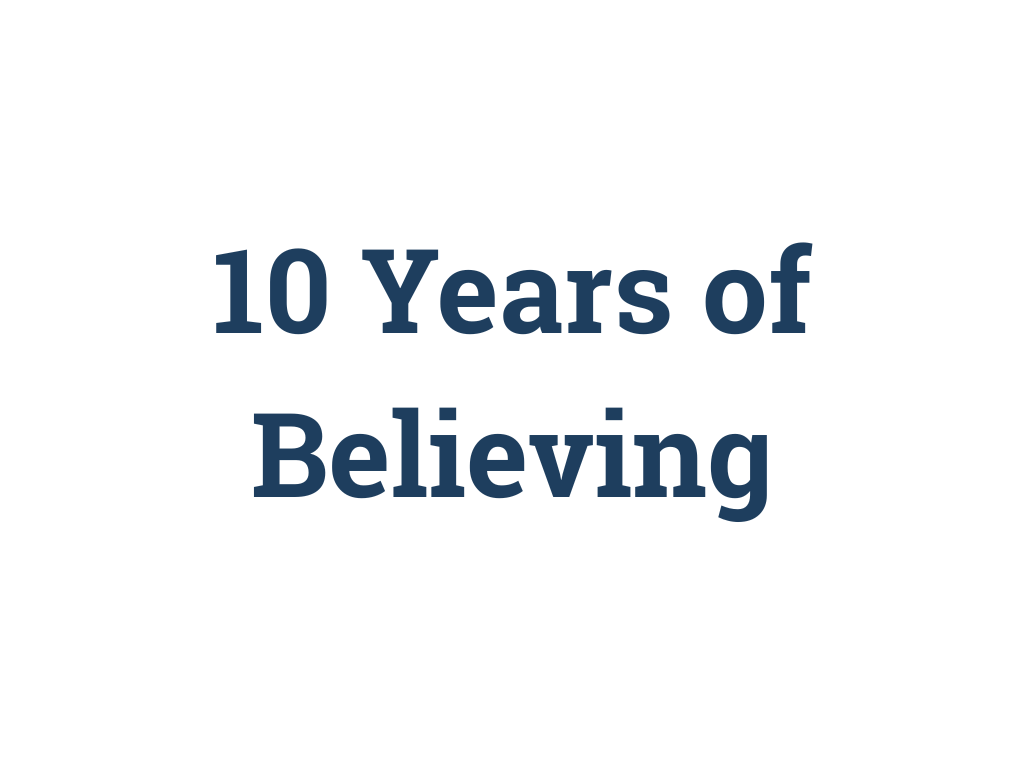 Text on a white background that reads '10 Years of Believing' in bold navy blue font.
