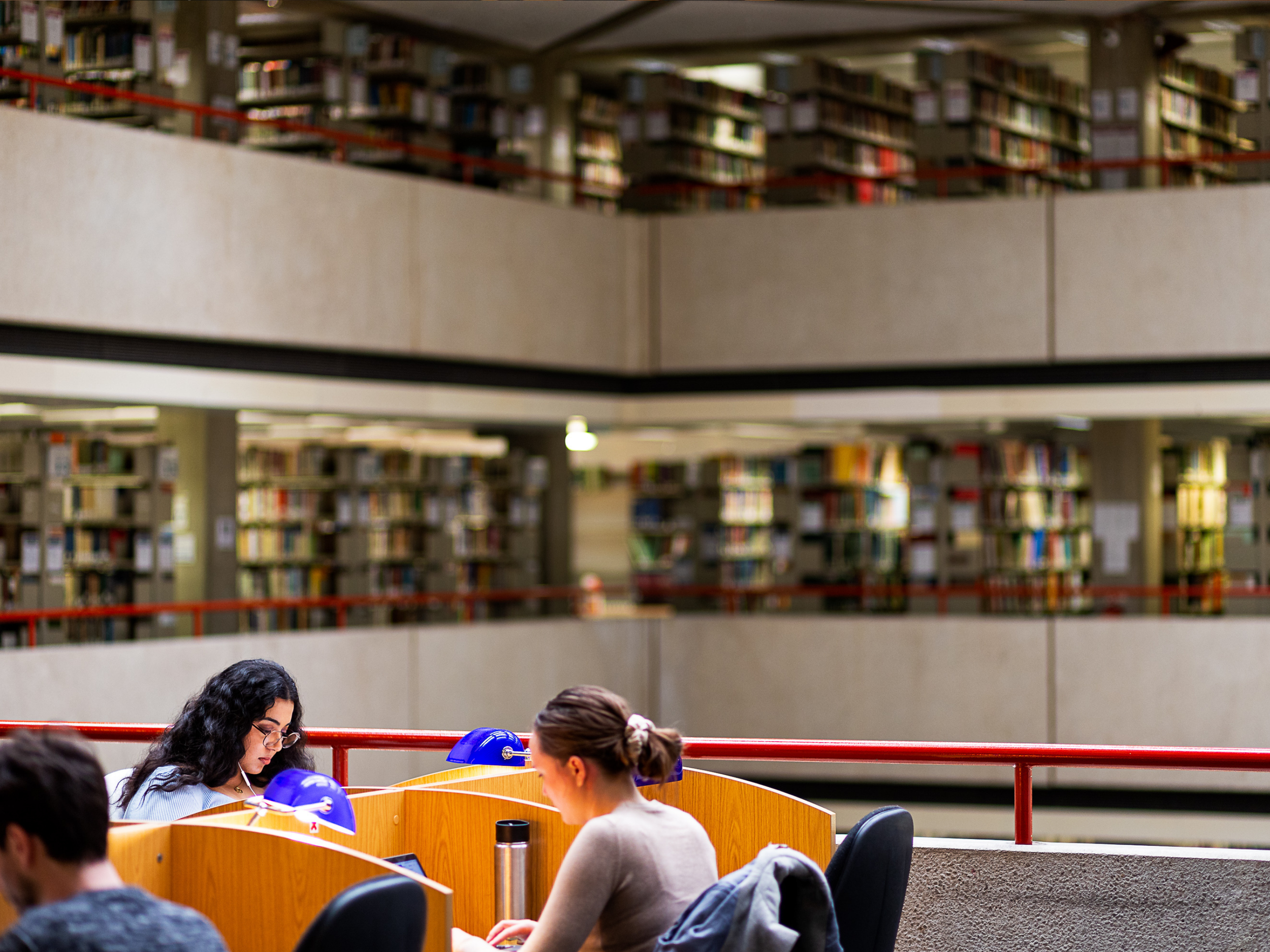 Abstract digital landscape of flowing waves made up of glowing dots in blue, purple and pink tones, suggesting data, sound or technological networks against a dark background.
