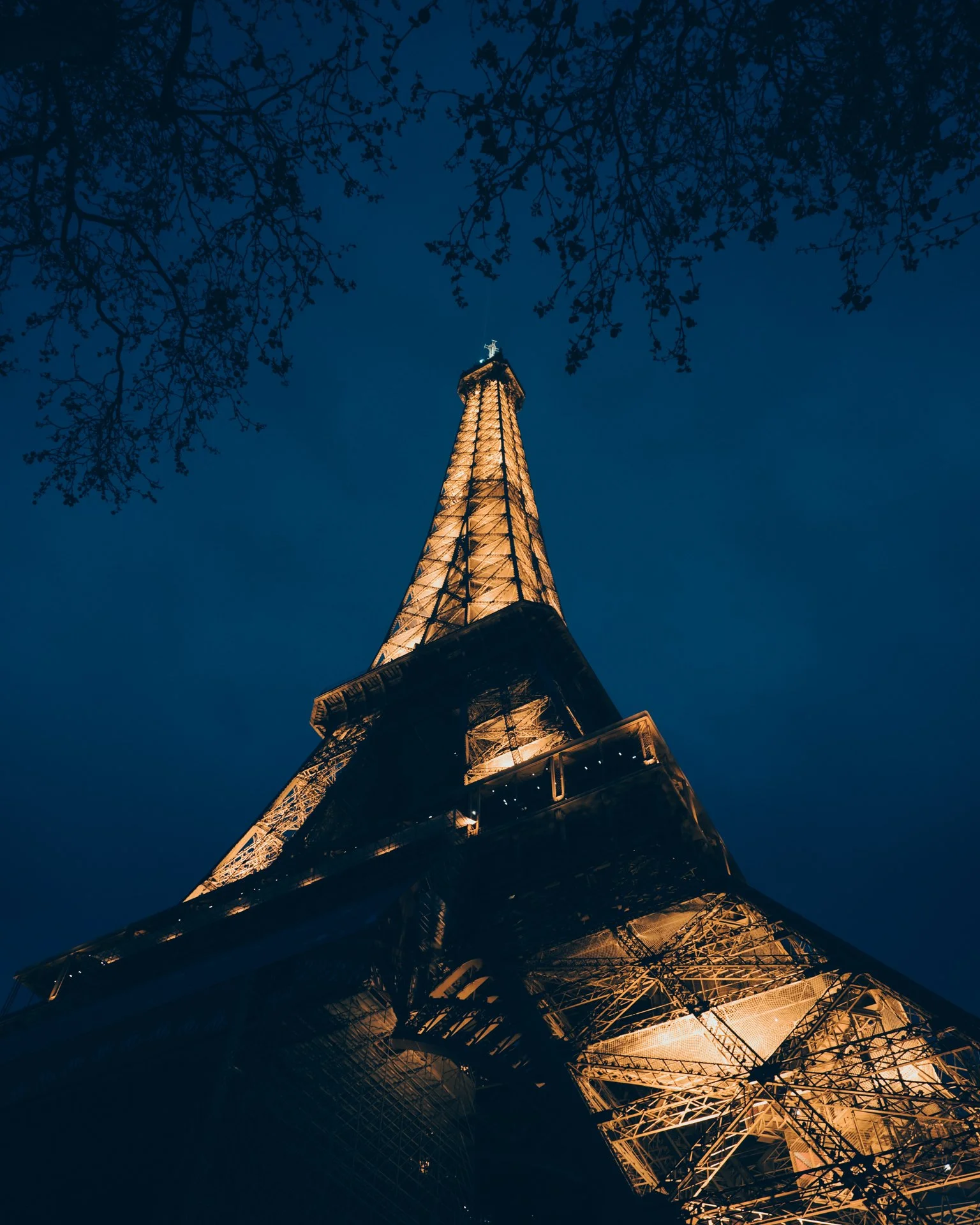Eiffel tower at night from low angle.jpg