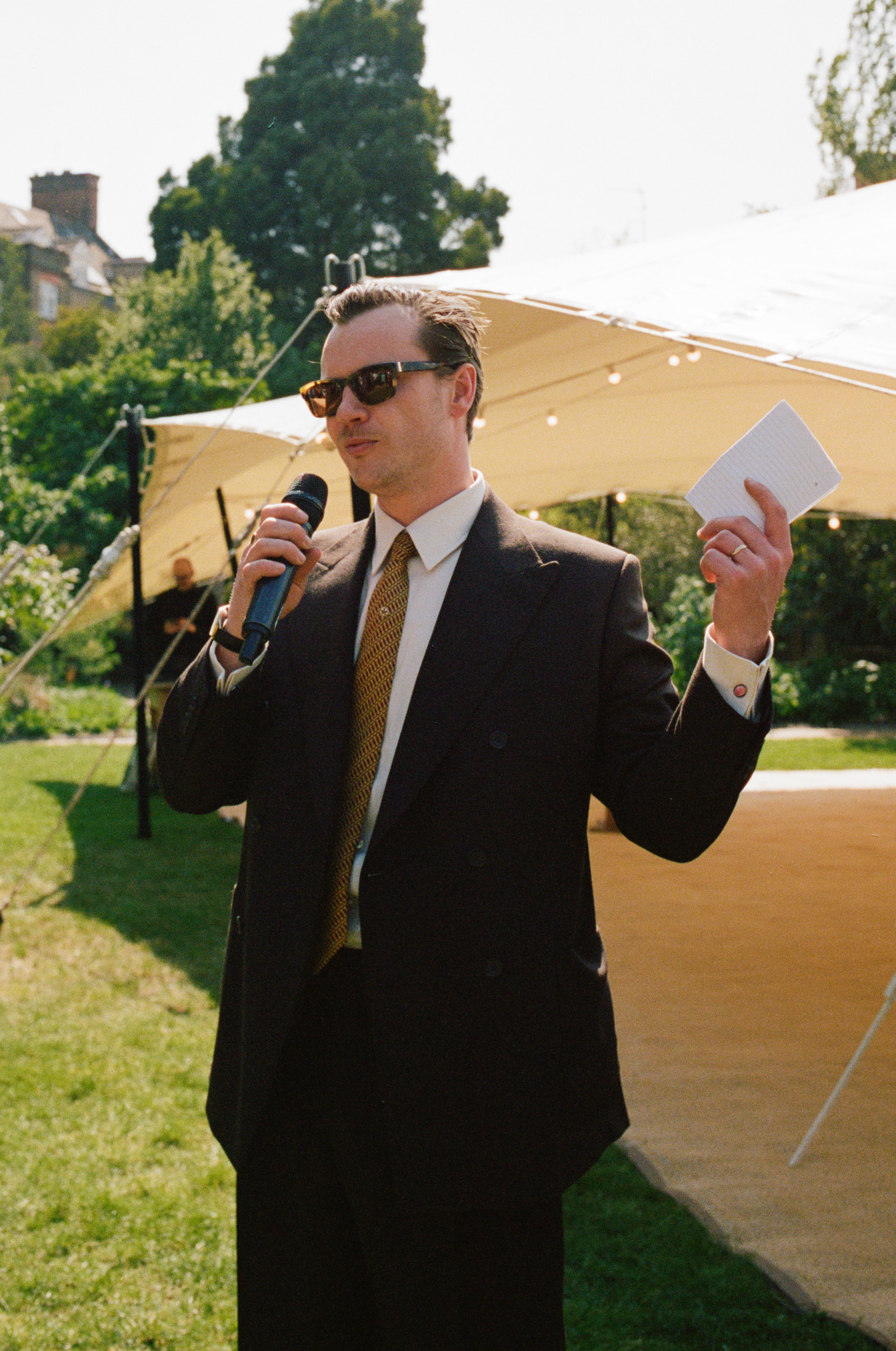 15 Harry doing his speech he wore a  brown suit in a 10oz lightweight wool double breasted with high rise pleated trousers .jpg