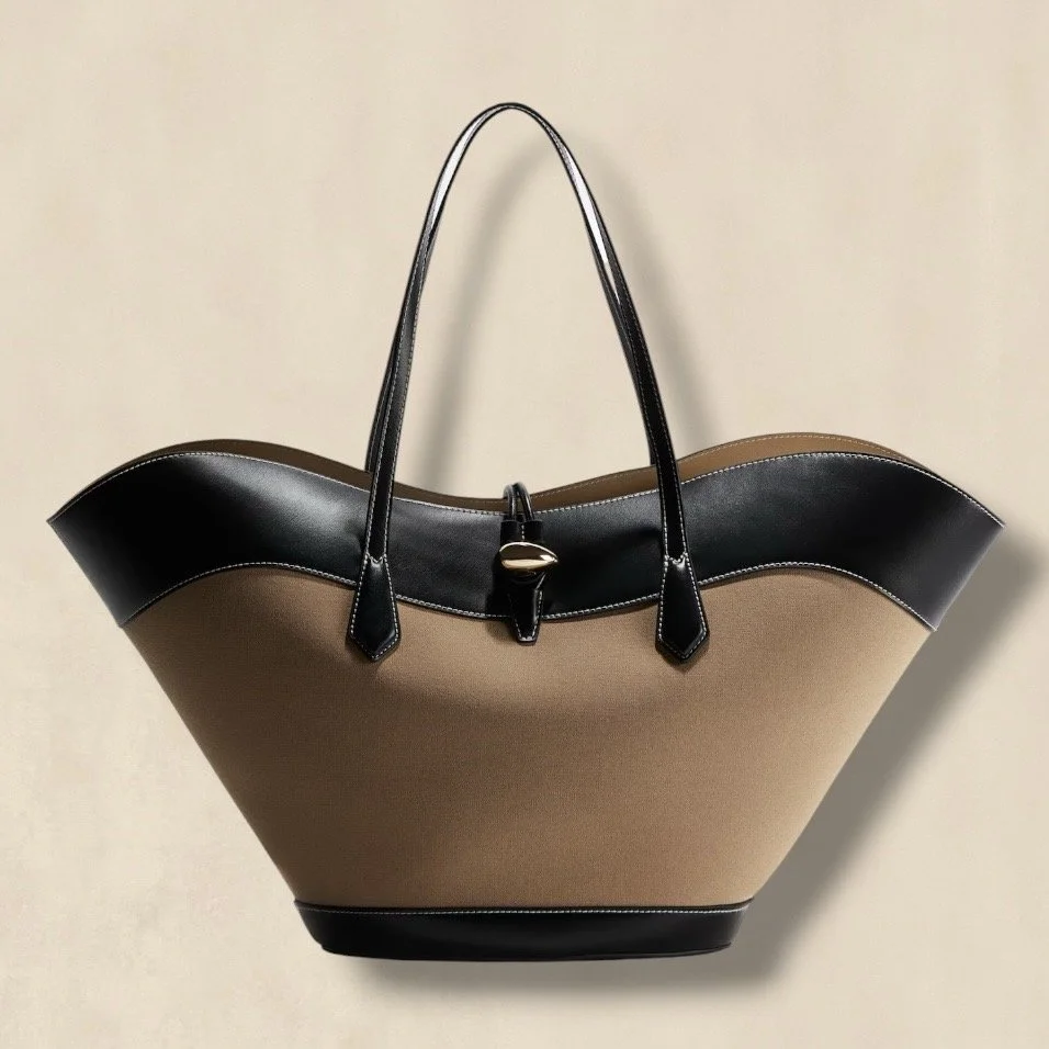Shopper With Distinctive Slanted Sides And A Wavy Top Edge.