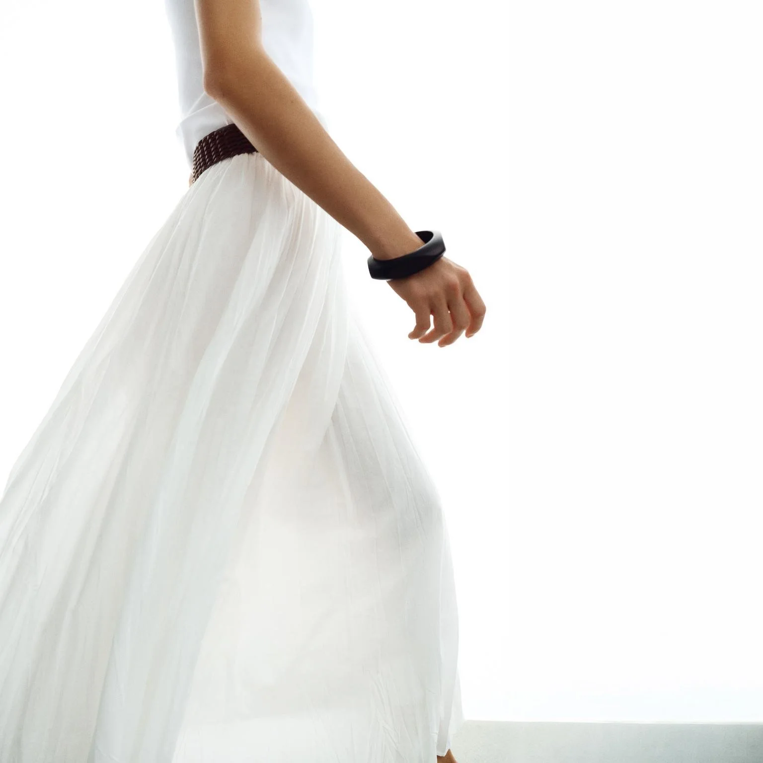 Flowing White Maxi Skirt With A Woven Brown Belt And Relaxed Shape