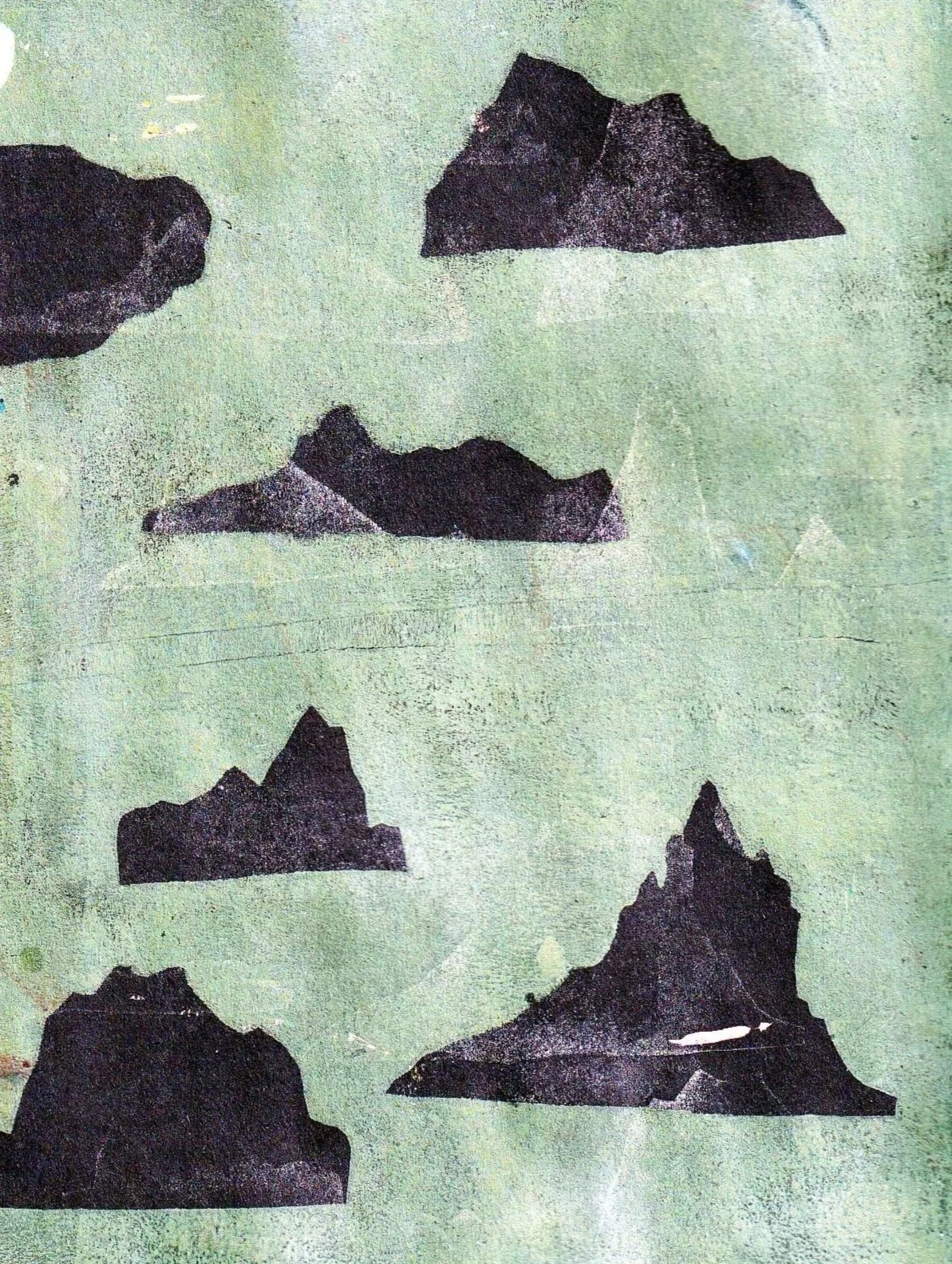 Five black mountain silhouette shapes printed on a light green textured background.