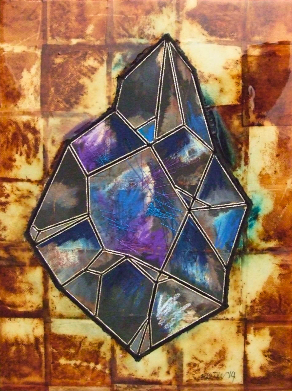 A geometric stained glass art piece with various shades of blue, purple, and black, mounted on a background of teabags.