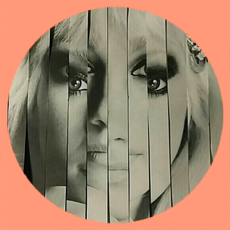 A circular artwork showing a distorted woman's face, woven in vertical paper strips, with large expressive eyes, a small nose, and partial lips, surrounded by a peach-colored background.