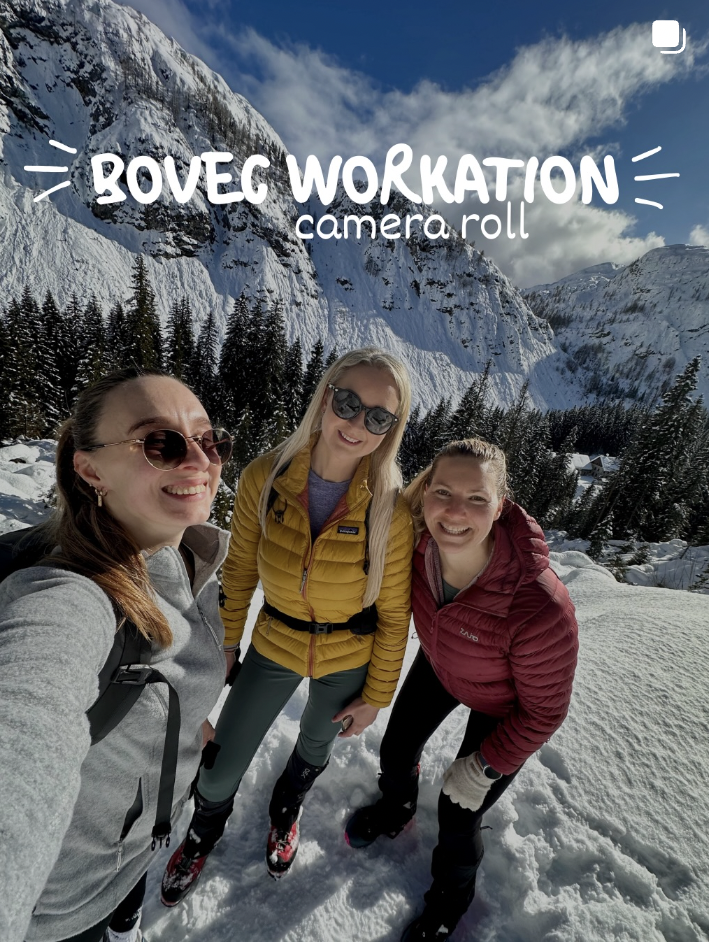 Three women smiling in snow with snowy mountains and pine trees in the background, dressed in winter hiking gear, with text overlay that reads 'Bovec Workout camera roll'.