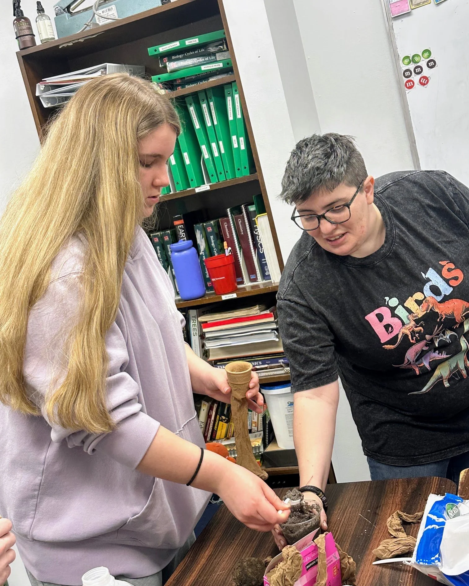 Science teacher Liz uses a lab to demonstrate germination differences in botany class