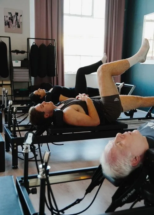 Students using the reformer pilates machines at the Kali Collective Yoga Studio in Glasgow