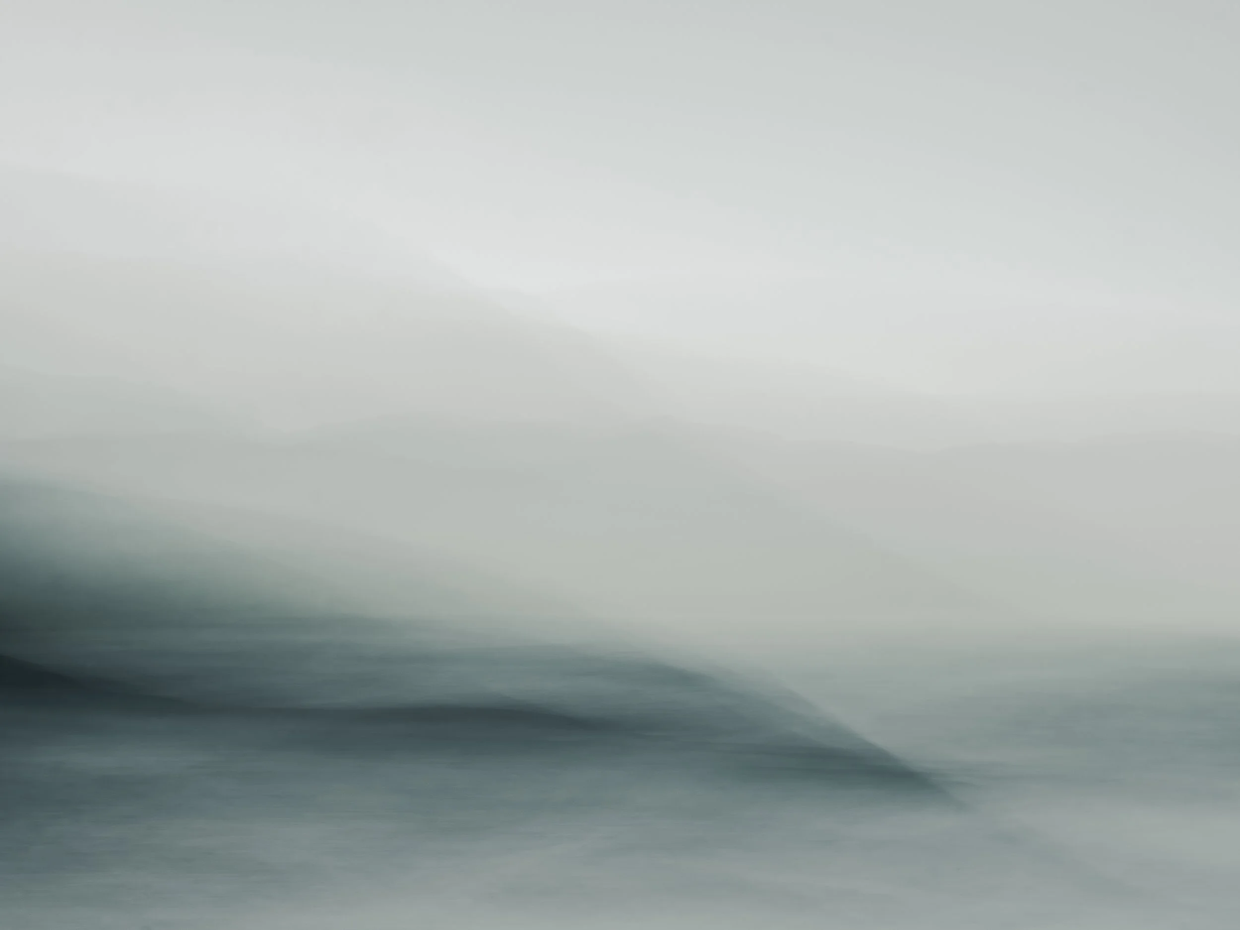 A serene fine art seascape created using Intentional Camera Movement (ICM), featuring soft, misty layers of blue and gray that blend seamlessly into a horizon of ethereal light. The fluid composition captures the quiet movement of water and air, evok