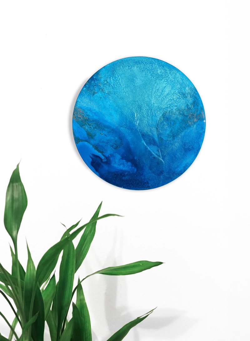 Discover "Oceanic Depths," a handcrafted resin artwork showcasing shimmering turquoise and aqua tones. Perfect for creating a serene coastal atmosphere in your space.