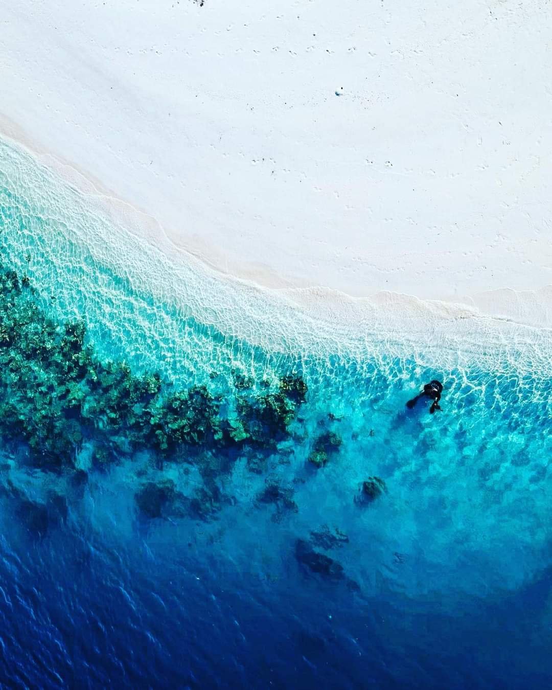Drone shot of ocean lapping to the shore inspiration for resin art.