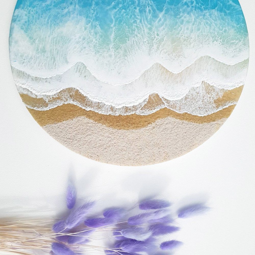 Resin artwork featuring vibrant blue ocean waves and sand tones, ocean inspired.
