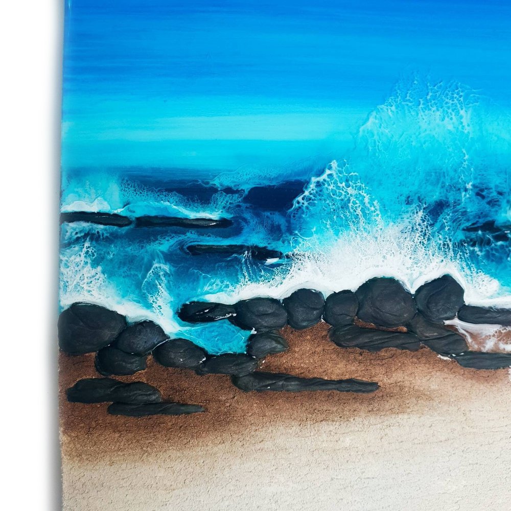 Close up of ocean-inspired resin painting with turquoise and emerald tones, capturing abstract beach beauty.