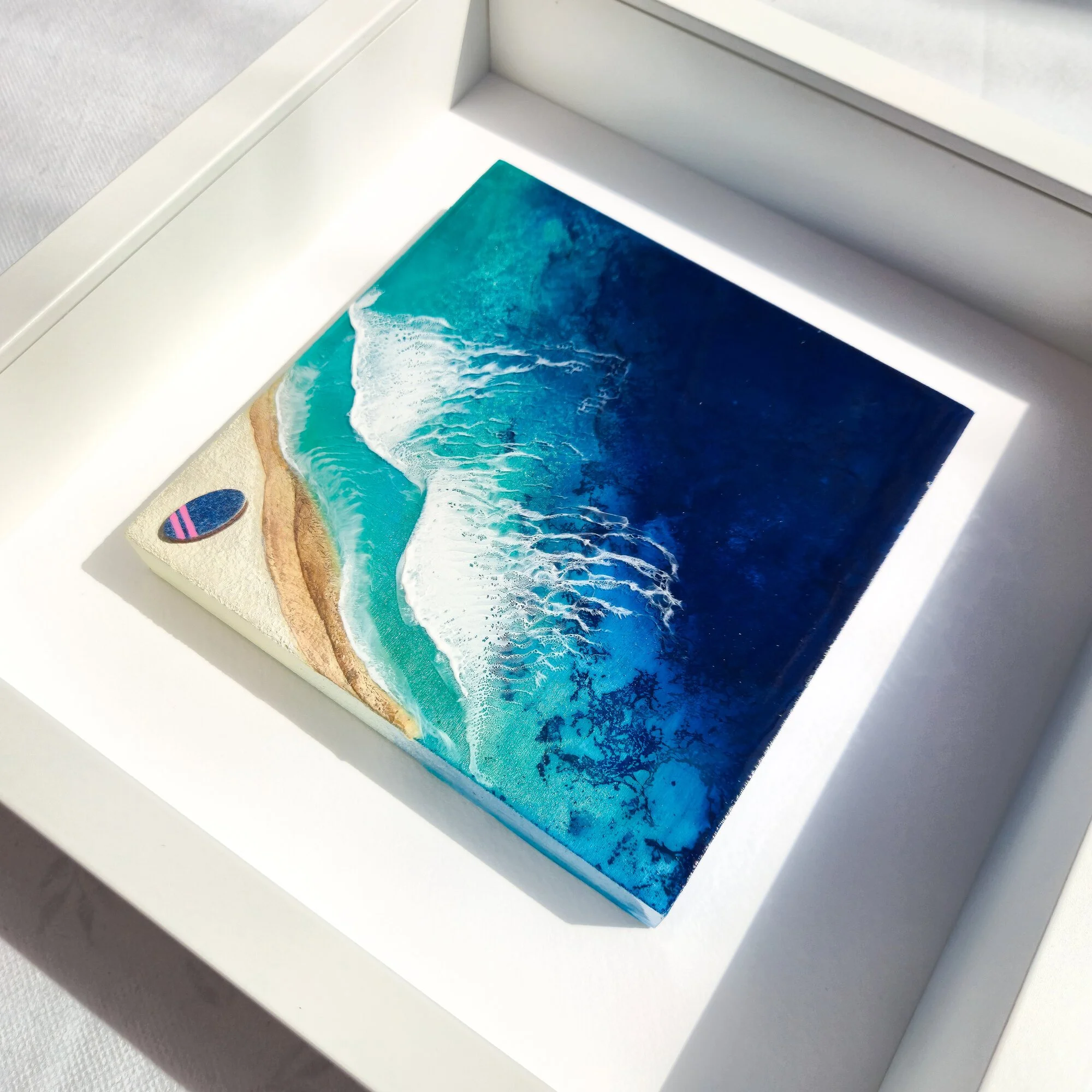 Layered resin surf artwork, Never Stop Dreaming, showing a surfer riding a wave at dawn with abstract ocean depth