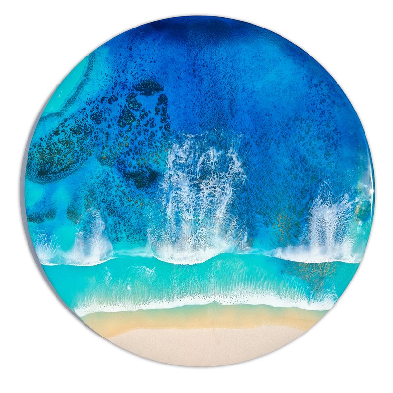 Ocean-inspired resin painting with turquoise and cerulean blue tones, capturing rocky reefs as waves lap to shore.