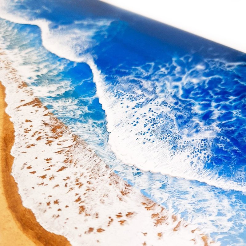 Close up of ocean-inspired resin painting with turquoise and emerald tones, capturing abstract beach beauty.