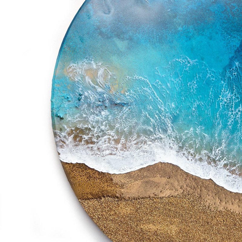 Close up of ocean-inspired resin painting with turquoise and emerald tones, capturing abstract beach beauty.