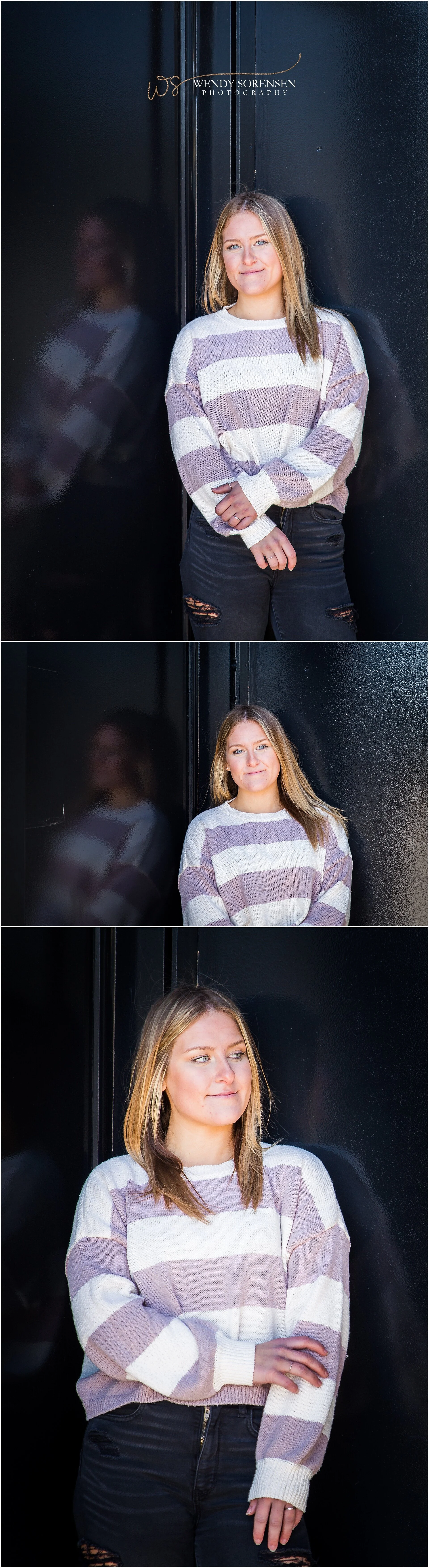 Senior girl leaning against a glossy black wall, reflecting her image, in Des Moines.