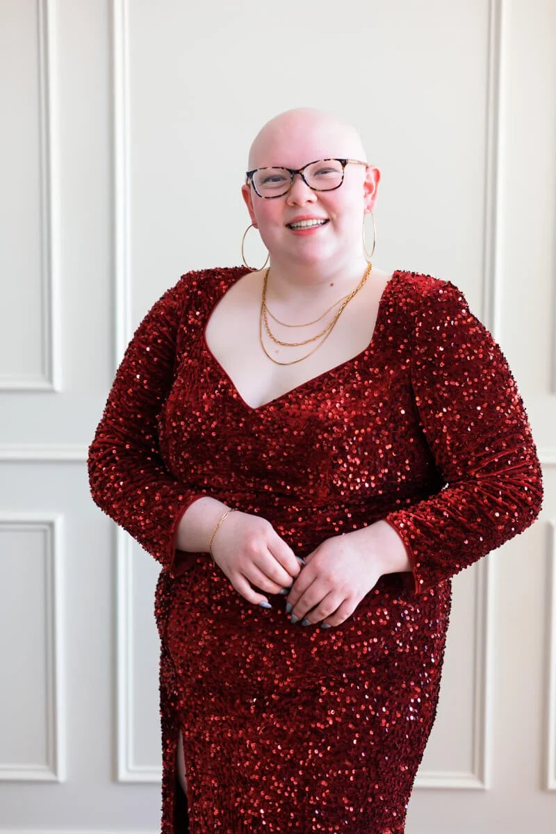 Close up photo of senior girl in red sequin prom dress.