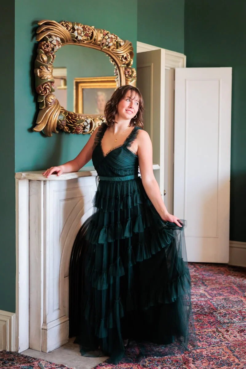 High school senior girl in dark green ruffled prom dress in Des Moines, Iowa.