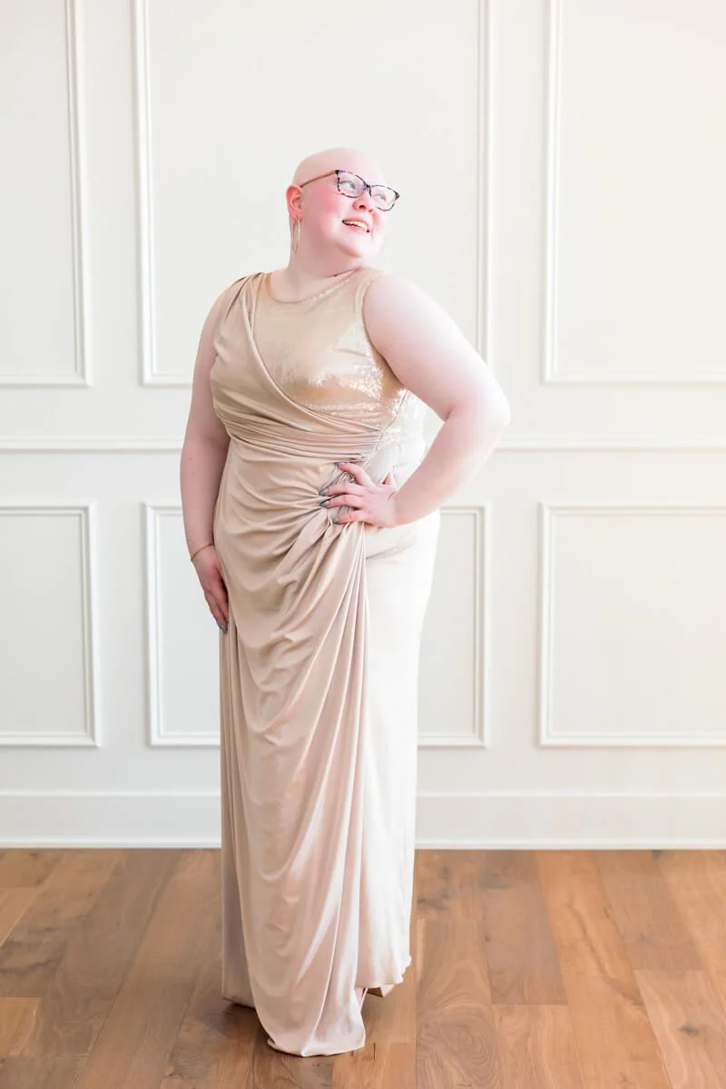 High school senior girl wearing a thrifted champagne colored prom dress.